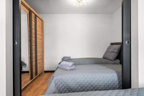 a bedroom with two beds and a mirror at Central Platinum Apartments 13 in Rybnik