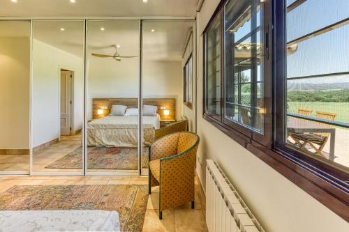 a bedroom with a bed and a large window at Villa Greta in Navata