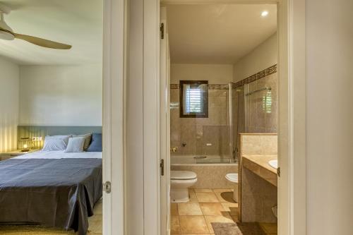 a bedroom with a bed and a tub and a toilet at Villa Greta in Navata