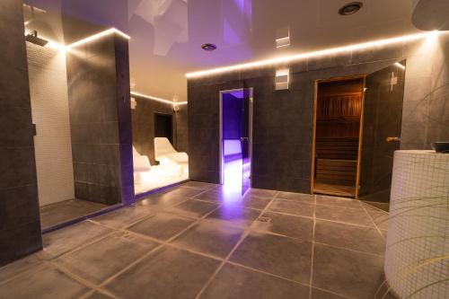 a hallway with a tile floor and a purple light at Chalet - AQUA MARIA RESORT in Veľaty