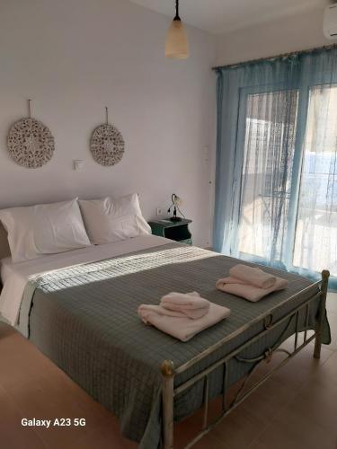 a bedroom with a bed with two towels on it at Menidi Sea View 302 in Menídion