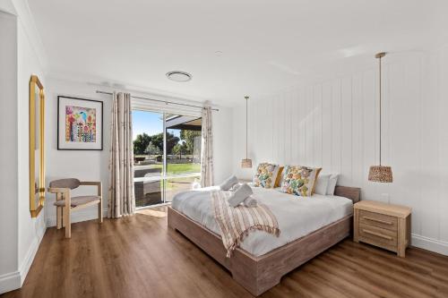 a bedroom with a large bed and a window at Rileystone in Margaret River Town