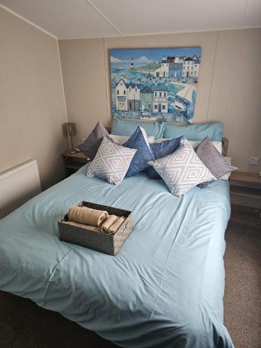a blue bed with a box on top of it at Iris - D6 in Eyemouth