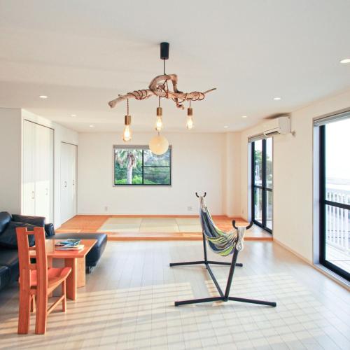 a living room with a couch and a chair at HOJO Brewing & Stays in Hōjō
