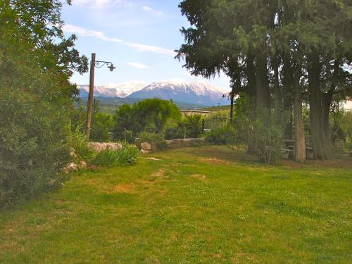 a view of a snow covered mountain from a yard at Agriturismo "Borgo Madonna degli Angeli" - charming cottages in the gardens ! in Tocco da Casauria