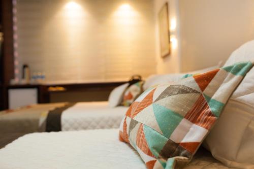 a hotel room with two beds and a blanket at Hotel Cortez in Santa Cruz de la Sierra