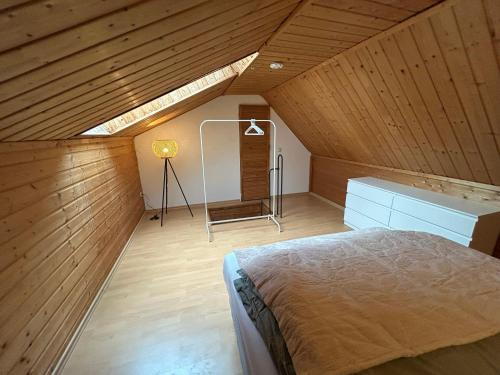 a attic bedroom with a bed and a lamp at Stadtloft am Schillerpark in Dessau