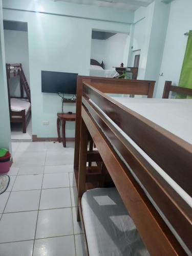 a dining room with a table and a bench at Yasmin's Transient House in Pagudpud
