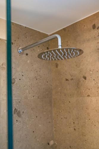 a shower with a shower head in a bathroom at Ble city in Karpathos