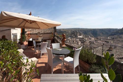 
a patio area with a patio table and chairs at Casa Diva in Matera
