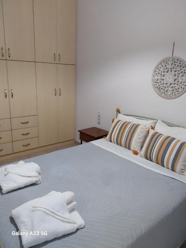 a bedroom with a bed with white towels on it at Menidi Apartment 201 in Menídion