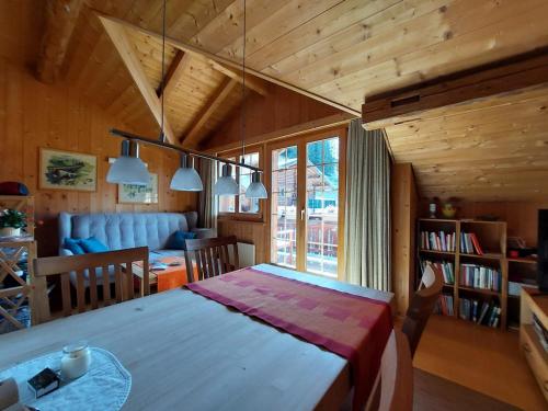 a living room with a table and a dining room at Stilvolle 3,5 Dachwohnung "Alpenblick" in Davos