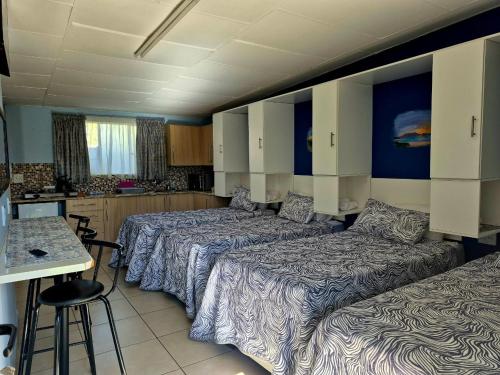 a hotel room with two beds and a kitchen at Danrit Guesthouse - Uncapped wifi in Roodepoort