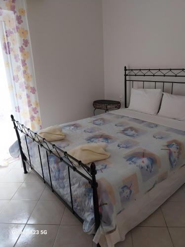 a bedroom with a bed with a comforter on it at Menidi apartment 202 in Menídion