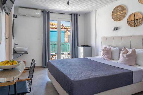 a bedroom with a bed and a table and a balcony at Australia in Skiathos