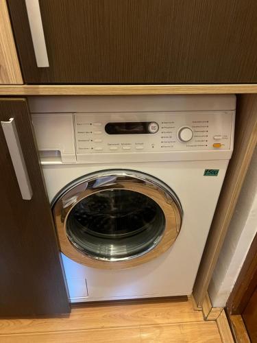 a washer and dryer sitting inside of a cabinet at Perla Central Apartment in Zalău
