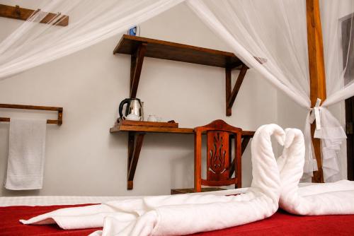 a bedroom with a bed with white sheets at Villa Serene Herbs Dickwella in Dickwella