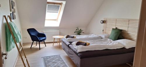 a small room with a couch and a chair at Groennebaek Bed and Breakfast in Føvling