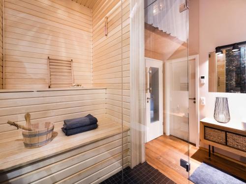 a sauna with wooden walls and a glass door at Stilvolles Wellnes-Refugium mit Privatsauna, Whirlwanne & Kamin im historischen Gut in Großharthau
