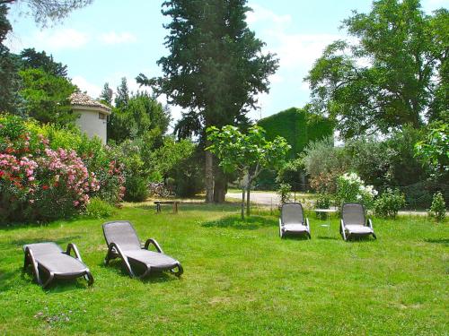 a group of chairs sitting in the grass at Agriturismo "Borgo Madonna degli Angeli" - charming cottages in the gardens ! in Tocco da Casauria