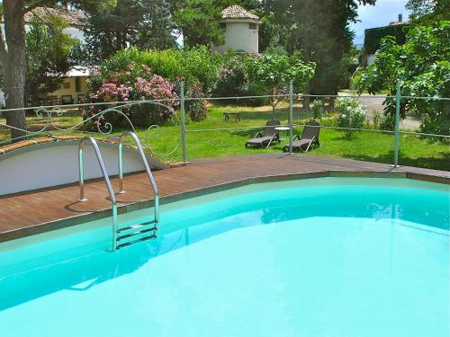 a large blue swimming pool in a yard at Agriturismo "Borgo Madonna degli Angeli" - charming cottages in the gardens ! in Tocco da Casauria