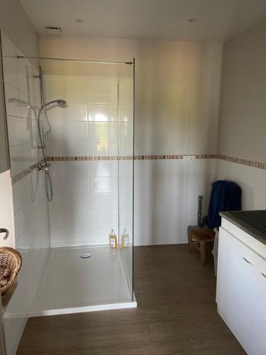 a shower with a glass door in a bathroom at Eden in Ceton