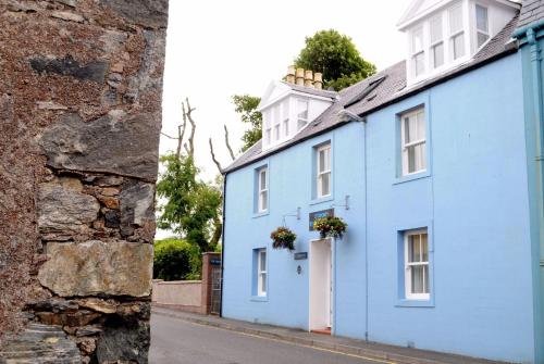 a blue house on the side of a street at Stornoway Bed and Breakfast in Stornoway