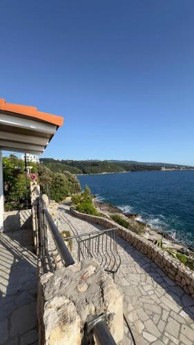 a building with a view of a body of water at Luka private beach in Dobra Voda