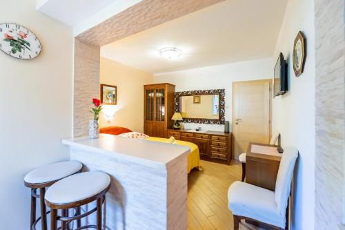 a hotel room with a kitchen and a bedroom at Rooms Nadica in Baška