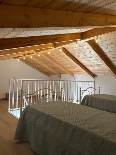 a room with a bed and a wooden ceiling with lights at Il Borghetto in Palinuro