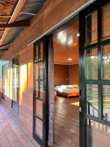 a room with a door leading to a bedroom at Dico Surf Point- Surf Lodge in Simeulue in Lasikin