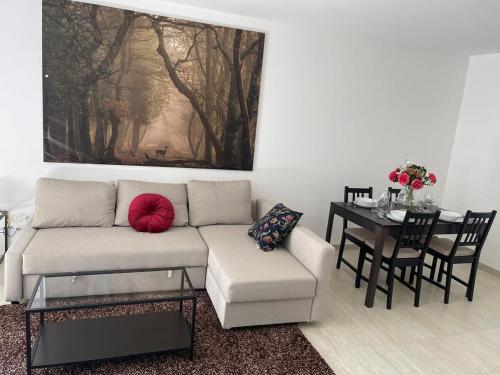 a living room with a couch and a table at Apparté - Appartement proche Genève et Palexpo in Ferney-Voltaire