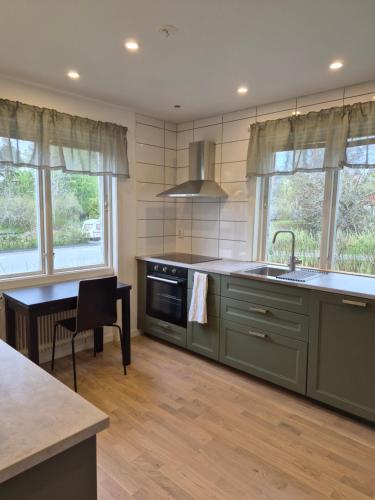 a kitchen with a sink and a stove at Lägenhet i Sandhem in Sandhem