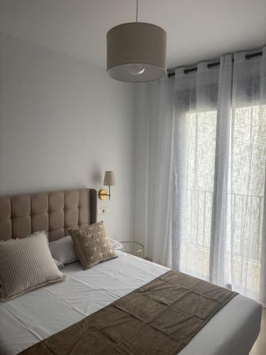 a bedroom with a large bed with a large window at Fuente De La Salud in Priego de Córdoba
