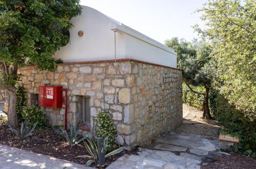 a stone building with a red telephone box on it at Odette Pansiyon Bodrum in Bodrum City
