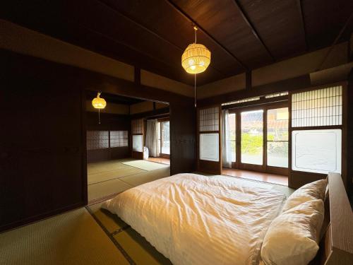 a bedroom with a bed in a room with windows at #12 Sekigahara Hotaru in Sekigahara