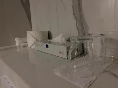 two glass vases sitting on a counter next to a box at Hotel Hvolsvollur - Central South Iceland in Hvolsvöllur