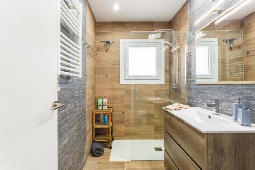 a bathroom with a sink and a shower at Villa Toro in Maçanet de la Selva