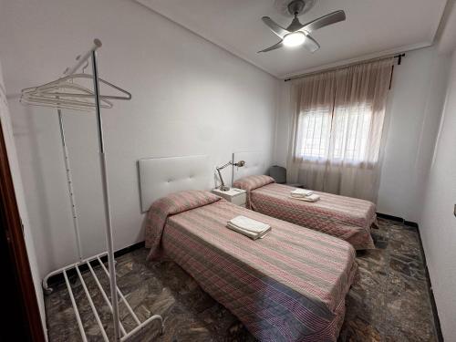 a hotel room with two beds and a ceiling fan at Casa Juani in Ateca
