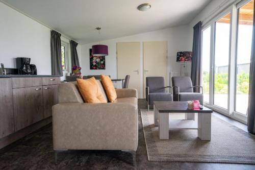 a living room with a couch and a table at EuroParcs Markermeer in Bovenkarspel