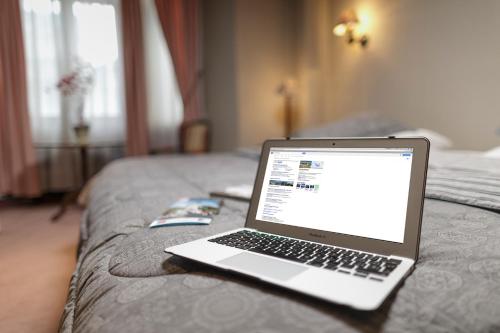 a laptop computer sitting on top of a bed at Hotel Isla Rey Jorge in Punta Arenas