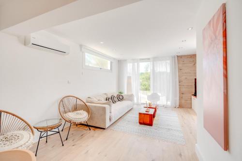a white living room with a couch and chairs at Seaside Hideaway Villa in Perivolia