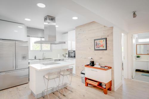a white kitchen with a sink and a counter at Seaside Hideaway Villa in Perivolia