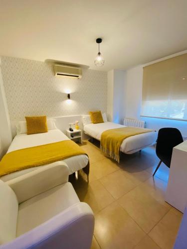 a hotel room with two beds and a window at Hotel Felix in Lorca