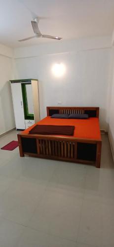 a bedroom with two beds and a mirror at Roamwander APARTMENT in Vagamon