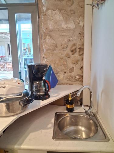 a kitchen sink with a coffee maker on a counter at Sea & Sun in Gialova