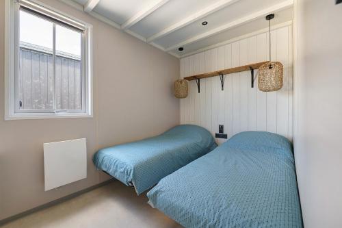 a bedroom with two beds and a window at Martinette in Saint-Pair-sur-Mer