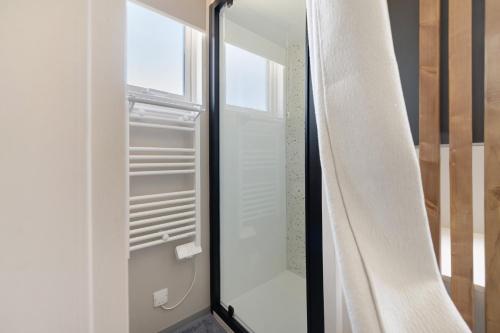 a glass refrigerator with a window and a curtain at Martinette in Saint-Pair-sur-Mer