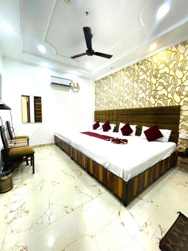 a bedroom with a large bed in a room at Hotel Embassy In - 200 Mtrs - Near Golden Temple in Amritsar