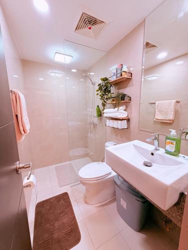 a bathroom with a sink and a toilet and a shower at Gabbys Place in Bacolod